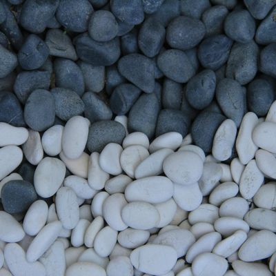 A stack of perfectly balanced smooth stones against a dark background.