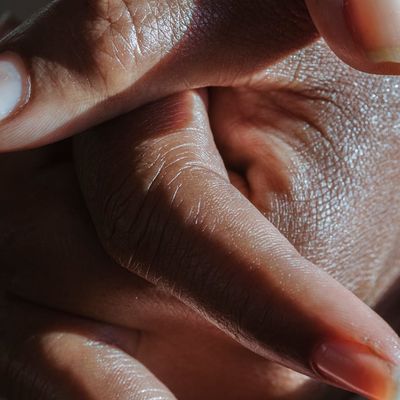 Close-up of a person's hands clasped during a moment of focus.